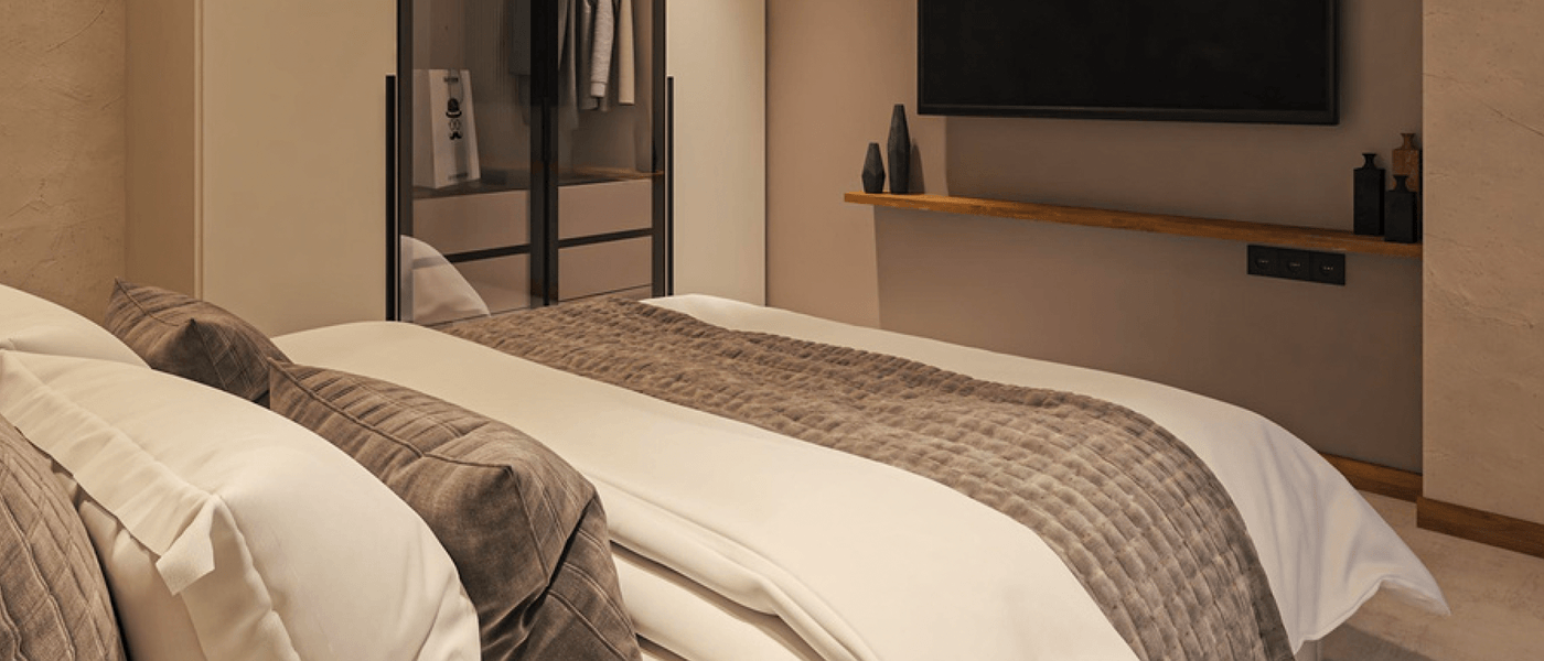 One-bedroom suite with mounted TV and built-in wardrobe