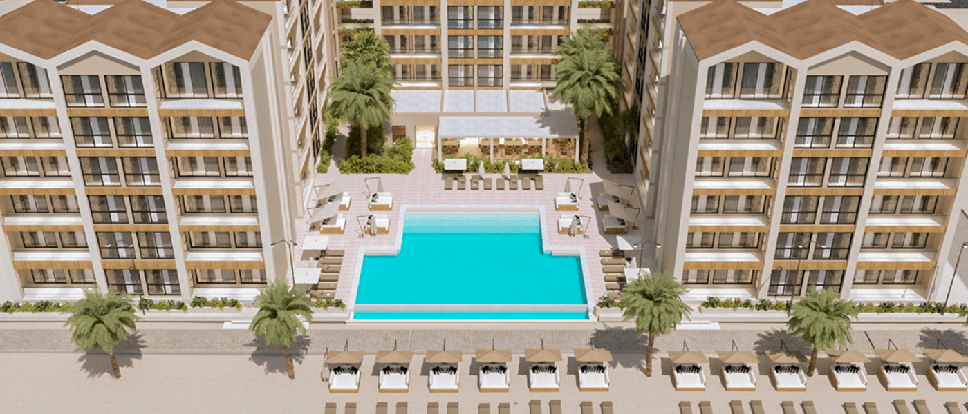 Aerial view — pool deck and beachfront promenade between Majestic buildings